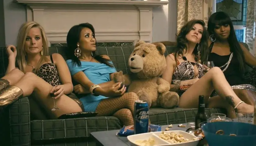Ted 3: pluszowy miś i cztery kobiety siedzą na kanapie, pijąc i jedząc przekąski.